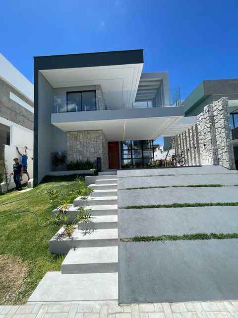 Residência duplex · Terras Alphaville · Pedra natural e varanda em vidro